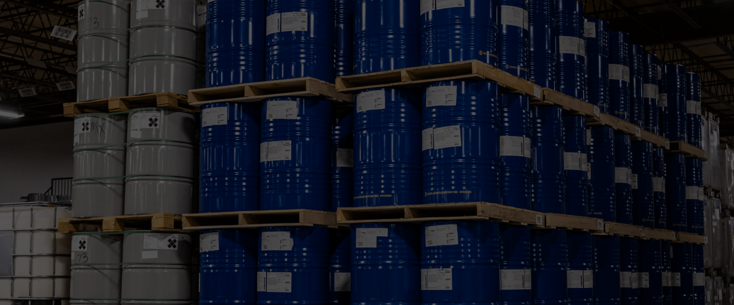 Barrels on pallets stacked on top of each other in a warehouse