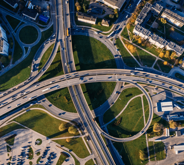 A birds-eye view of two high ways intersecting over a roundabout