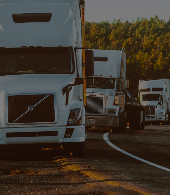 Three trucks parked in front of one another facing the camera