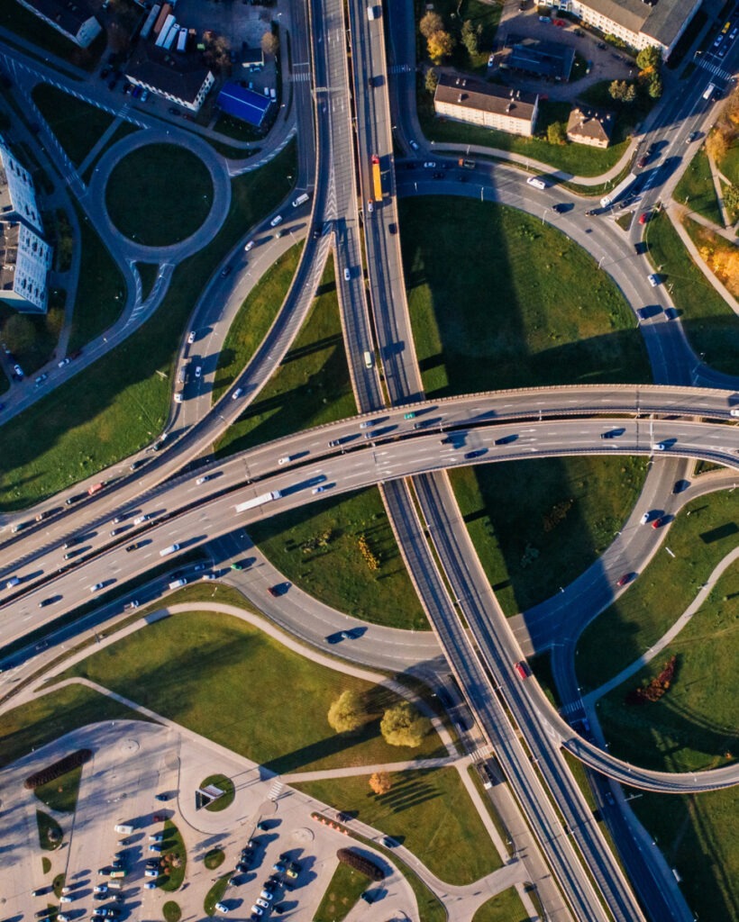 A birds-eye view of two high ways intersecting over a roundabout